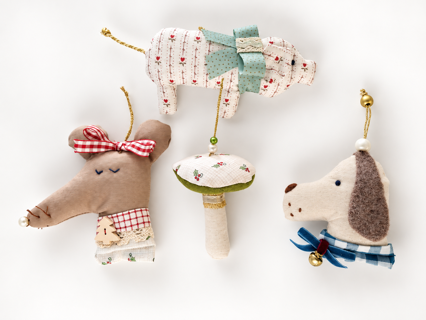 Four handmade textile ornaments, including a pig, mushroom, bird and mouse
